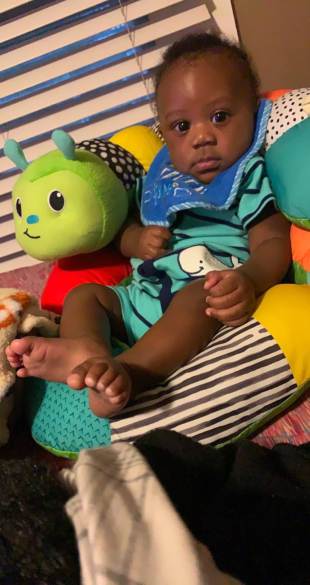 Jasahn is registered to the contest to win money with this photo: adaptation, arm, baby, baby_products, baby_toddler_clothing, chair, child, comfort, facial_expression, fun, green, happy, head, person, play, sitting, skin, stuffed_toy, textile, toddler