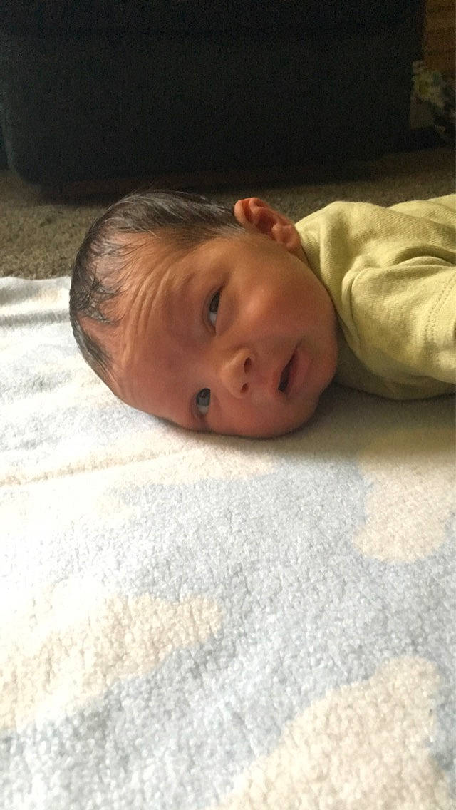 Azrael is registered to the contest to win money with this photo: baby, bedding, bedtime, child, comfort, eye, floor, flooring, fur, grass, hardwood, head, linens, nap, nose, person, portrait_photography, room, sleep, toddler