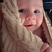 Rayne joined the competition — help win amazing prizes! baby, towel, face, child, skin, hand, smile, close_up, portrait, soft_texture, wrapped, cute, infant, warm, comfort, expression, eyes, indoors, cozy, young