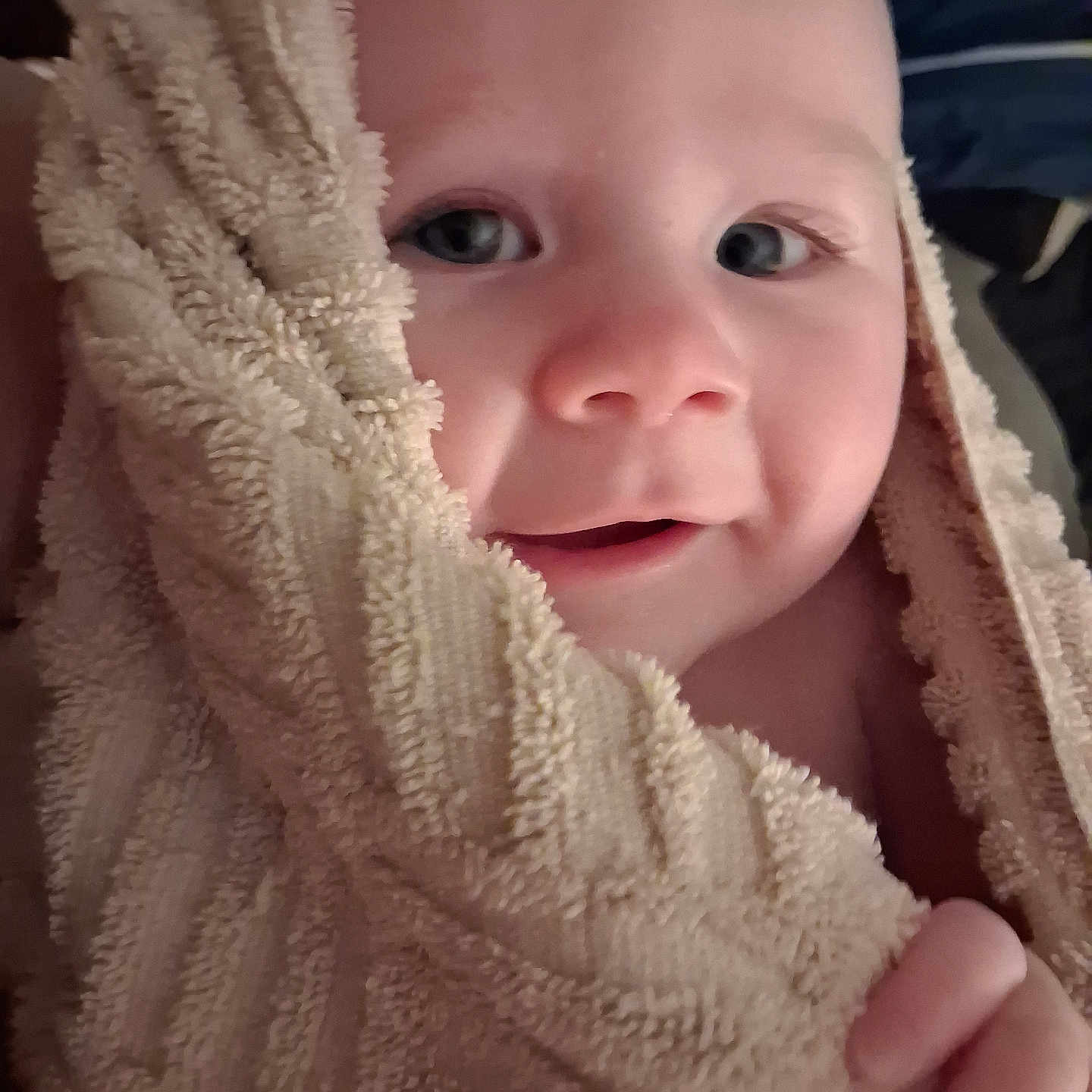Rayne joined the competition — help win amazing prizes! baby, towel, face, child, skin, hand, smile, close_up, portrait, soft_texture, wrapped, cute, infant, warm, comfort, expression, eyes, indoors, cozy, young