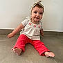 baby, child, sitting, floor, headband, red_pants, white_top, smiling, indoor, cute, portrait, person, happy, tiled_floor, young_child, infant, casual_clothing, headwear, barefoot, playful