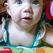 Mackenzie joined the competition — help win amazing prizes! baby, child, face, blue_eyes, curious_expression, colorful, playmat, indoors, closeup, portrait, person, young_child, sleeveless_clothing, earrings, infant, cute, bright, front_view, small_person, smiling