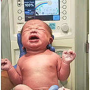 Mackenzie is registered to the contest to win money with this photo: baby, bed, child, clinic, crying, gloves, healthcare, holding, hospital, human, infant, medical_equipment, monitor, naked, newborn, patient, person, skin, temperature, weight