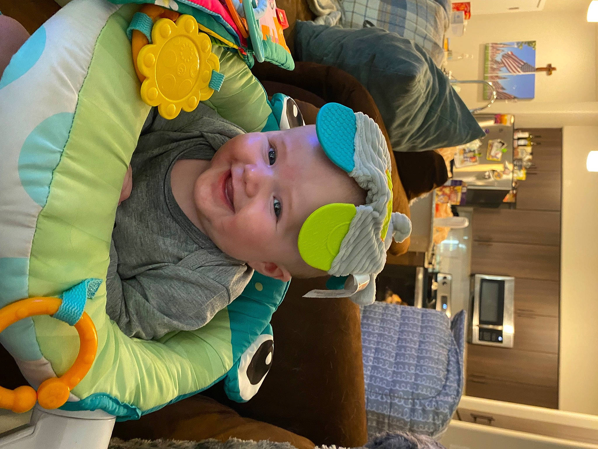Paxton is registered to the contest to win money with this photo: baby, baby_products, child, comfort, eyewear, fun, happy, hat, headwear, joy, leisure, mouth, person, play, recreation, room, sitting, smile, toddler, vacation