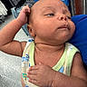 Zaylen is registered to the contest to win money with this photo: baby, infant, child, person, face, arm, clothing, onesie, store, shelf, box, floor, hand, head, skin, expression, looking, indoor, holding, curious