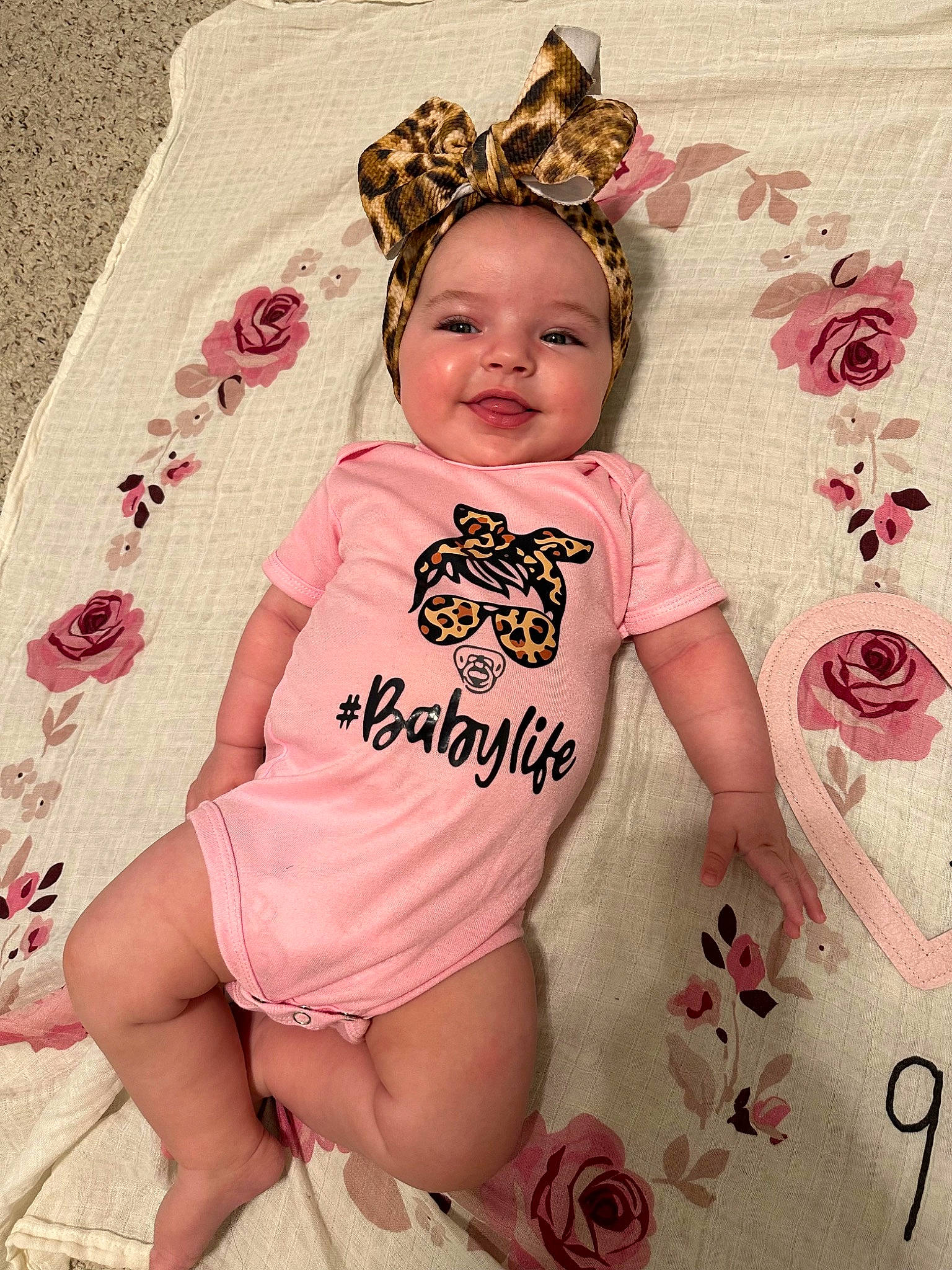 Gracelynn is registered to the contest to win money with this photo: baby, baby_toddler_clothing, child, costume_hat, fashion_accessory, font, happy, headpiece, joy, linens, magenta, pattern, person, pink, product, skin, sleeve, smile, t_shirt, textile