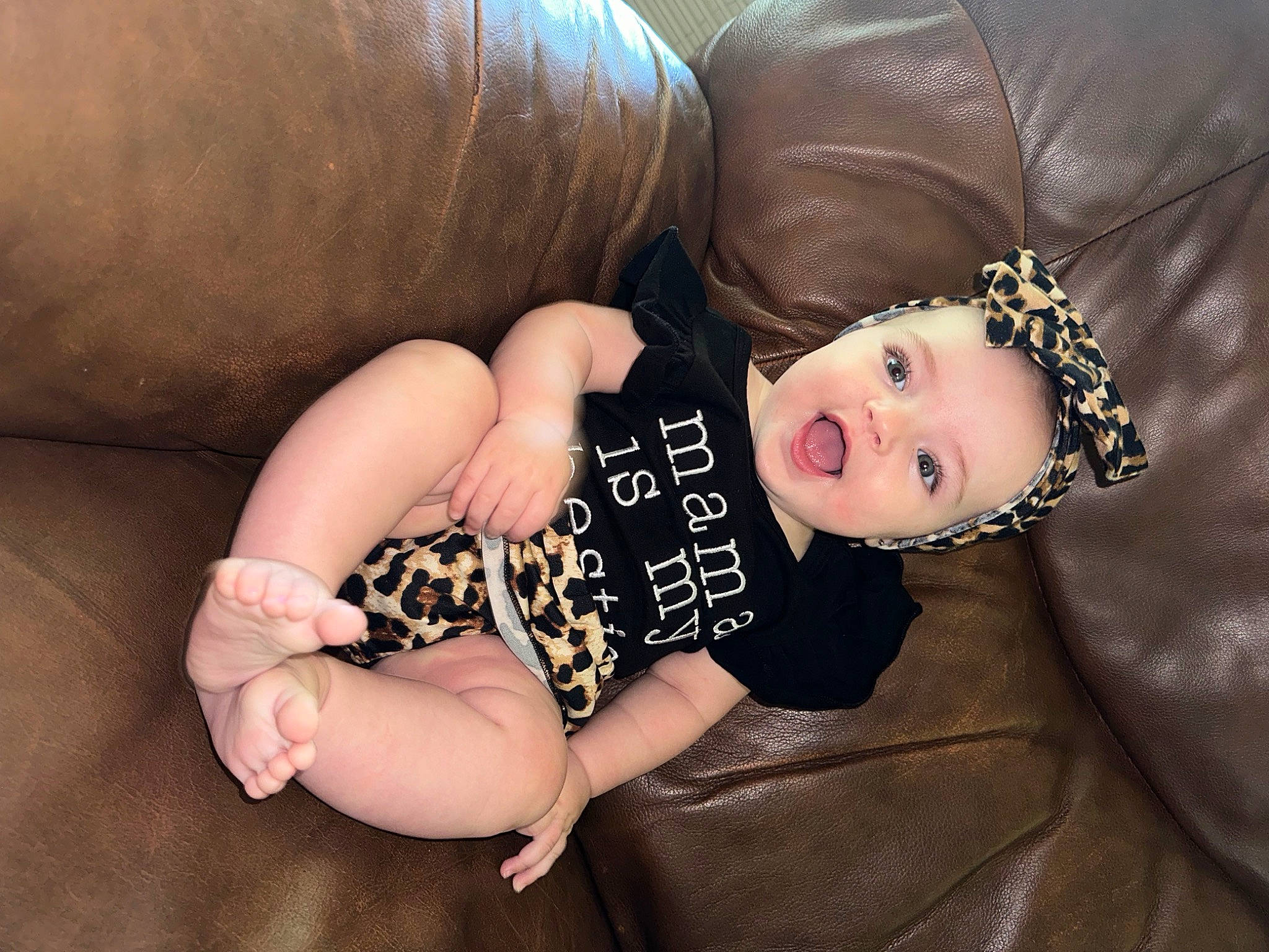 Gracelynn is registered to the contest to win money with this photo: baby_toddler_clothing, brown_hair, child, comfort, eye, facial_expression, finger, flash_photography, foot, head, human_body, human_leg, nail, neck, person, sitting, skin, sleeve, thigh, toddler