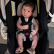 Theo joined the competition — help win amazing prizes! baby, car_seat, child, infant, straps, footwear, person, cute, indoor, looking, expression, clothing, seat, sitting, head, face, hand, legs, shoes, safety
