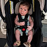 baby, car_seat, child, infant, straps, footwear, person, cute, indoor, looking, expression, clothing, seat, sitting, head, face, hand, legs, shoes, safety