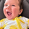 baby, blanket, cheerful, child, comfort, cozy, cute, expression, face, happy, head, indoors, infant, joy, person, portrait, seat, smiling, yellow_clothing, young