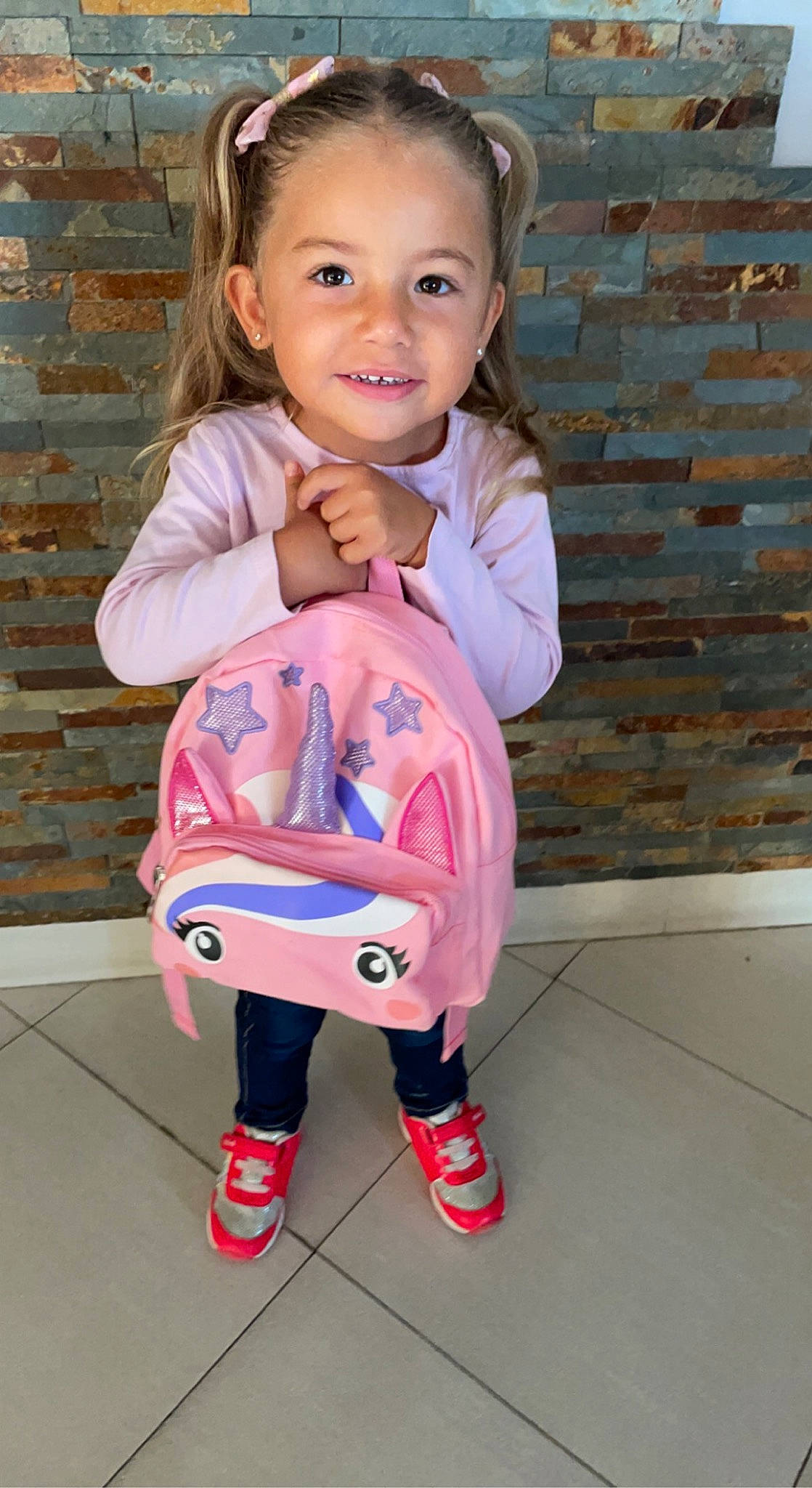 Kiara participe au concours pour gagner de l'argent avec cette photo : baby_toddler_clothing, cheek, clothing, cool, eye, face, finger, hair, happy, head, joint, joy, people, person, pink, purple, skin, sleeve, smile, standing