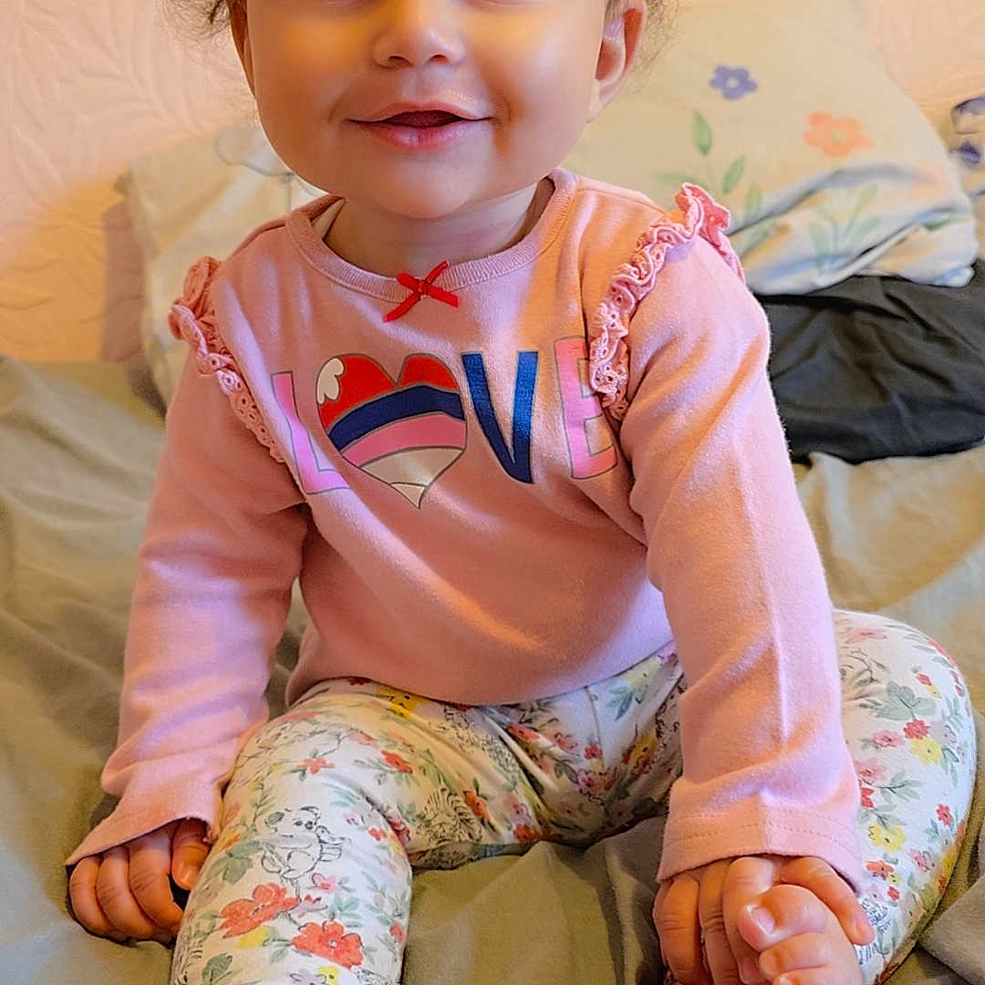 Alanna-Rai joined the competition — help win amazing prizes! ankle, baby, bed, bodypart, clothing, couch, face, finger, furniture, hand, happy, head, heel, pants, person, photography, portrait, shorts, sitting, smile