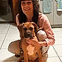 Chance joined the competition — help win amazing prizes! woman, dog, indoor, floor, tile, kitchen, cabinet, towel, smiling, pet, animal, brown_dog, white_patch, crouching, casual_clothing, home, person, companion, friendship, domestic