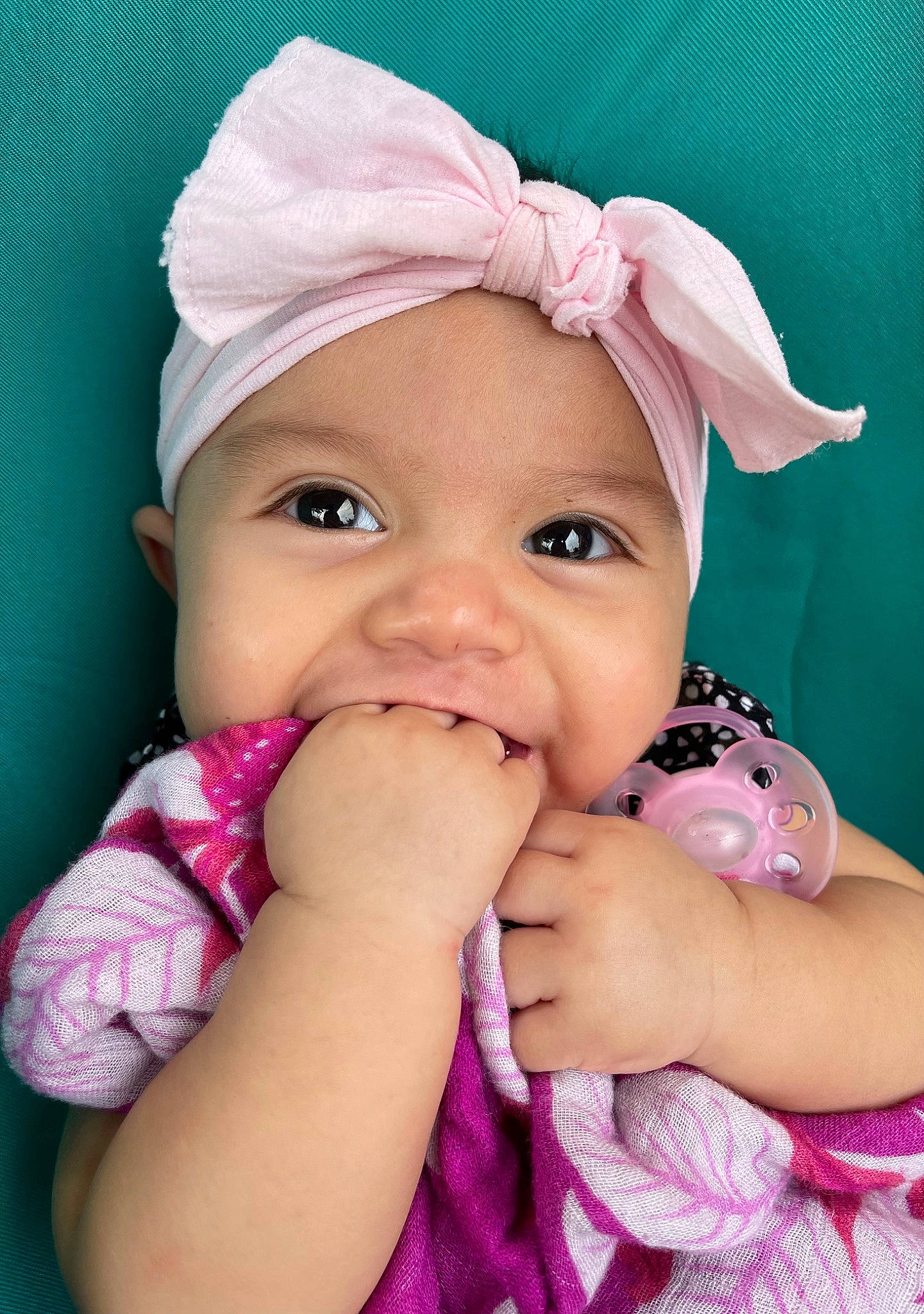 Kaia is registered to the contest to win money with this photo: arm, baby, cap, cheek, chin, clothing, eye, eyebrow, eyelash, hand, happy, headwear, iris, lip, mouth, nose, person, pink, product, purple