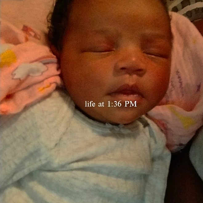 Ji'Ana is registered to the contest to win money with this photo: newborn, baby, sleeping, portrait, face, infant, blanket, swaddled, onesie, indoors, bed, cushion, resting, peaceful, closed_eyes, dark_hair, family, granddaughter, text_overlay, photograph