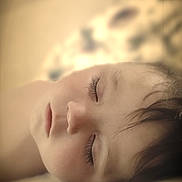 Cam is registered to the contest to win money with this photo: child, sleeping, face, closed_eyes, peaceful, portrait, soft_light, indoors, bed, cozy, young, rest, calm, hair, skin, closeup, serene, relaxation, comfort, quiet