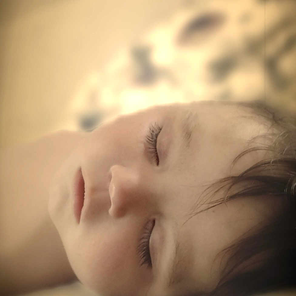 Cam is registered to the contest to win money with this photo: child, sleeping, face, closed_eyes, peaceful, portrait, soft_light, indoors, bed, cozy, young, rest, calm, hair, skin, closeup, serene, relaxation, comfort, quiet