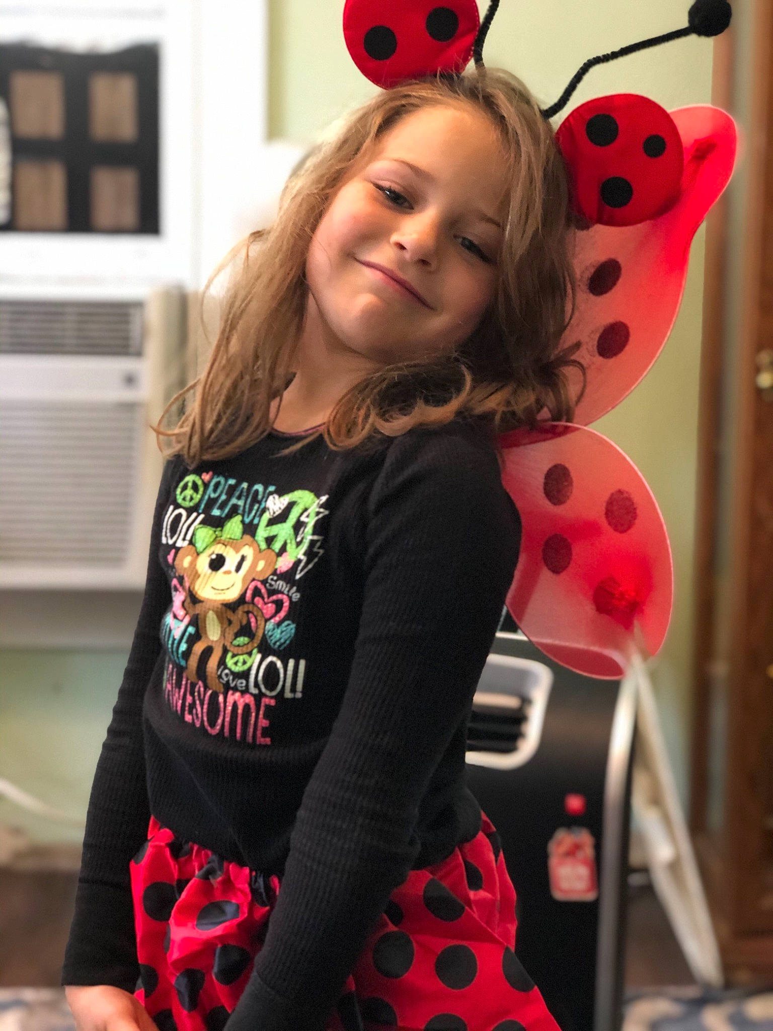 Sabrina is registered to the contest to win money with this photo: child, clothing, costume, design, ear, fashion, joy, ladybug, neck, outerwear, pattern, person, pink, polka_dot, sleeve, smile, t_shirt, toddler