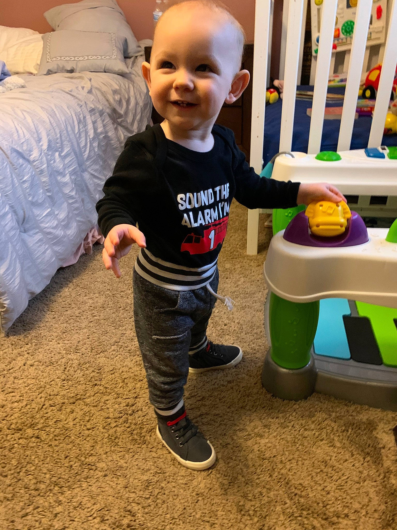 Alec joined the competition — help win amazing prizes! baby, baby_toys, child, floor, flooring, fun, furniture, joy, person, play, room, smile, standing, toddler, toy