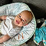 baby, blanket, blue_blanket, carpet, child, closeup, comfort, cozy, cushion, cute, face, happy, indoors, infant, light_skin, patterned_fabric, seated, smiling, water_bottle, white_shirt