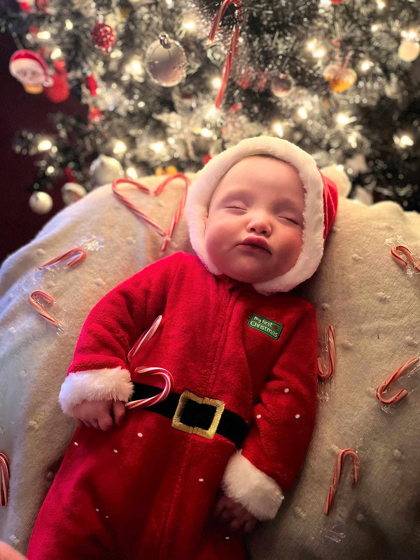 Kade joined the competition — help win amazing prizes! baby, infant, christmas, santa_suit, candy_cane, christmas_tree, ornament, lights, sleeping, cozy, blanket, holiday, festive, portrait, red_costume, hat, bokeh, indoor, cute, seasonal_decor