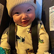 Kade joined the competition — help win amazing prizes! baby, infant, child, beanie, hat, car_seat, harness, onesie, toy, rattle, smile, happy, cheeks, closeup, portrait, indoor, playful, eyes, clothing, seat