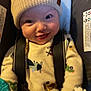 baby, infant, child, beanie, hat, car_seat, harness, onesie, toy, rattle, smile, happy, cheeks, closeup, portrait, indoor, playful, eyes, clothing, seat