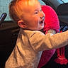 Nova is registered to the contest to win money with this photo: baby, child, toddler, smiling, laughing, face, portrait, car, vehicle, driver, steering_wheel, dashboard, seat, interior, pink_plush_toy, fuzzy_toy, onesie, indoor, happy, playful