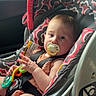 Nova joined the competition — help win amazing prizes! baby, infant, child, car_seat, vehicle, passenger, pacifier, toy, harness, safety_belt, sitting, indoors, travel, car, patterned_fabric, portrait, wide_eyed, daylight, window, family