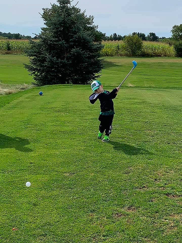 Benton is registered to the contest to win money with this photo: ball_game, competition_event, golf, golf_club, golf_course, golf_equipment, golfer, grass, grass_family, grassland, headwear, lawn, meadow, person, pitch_and_putt, plant, professional_golfer, recreation, sport_venue, sports