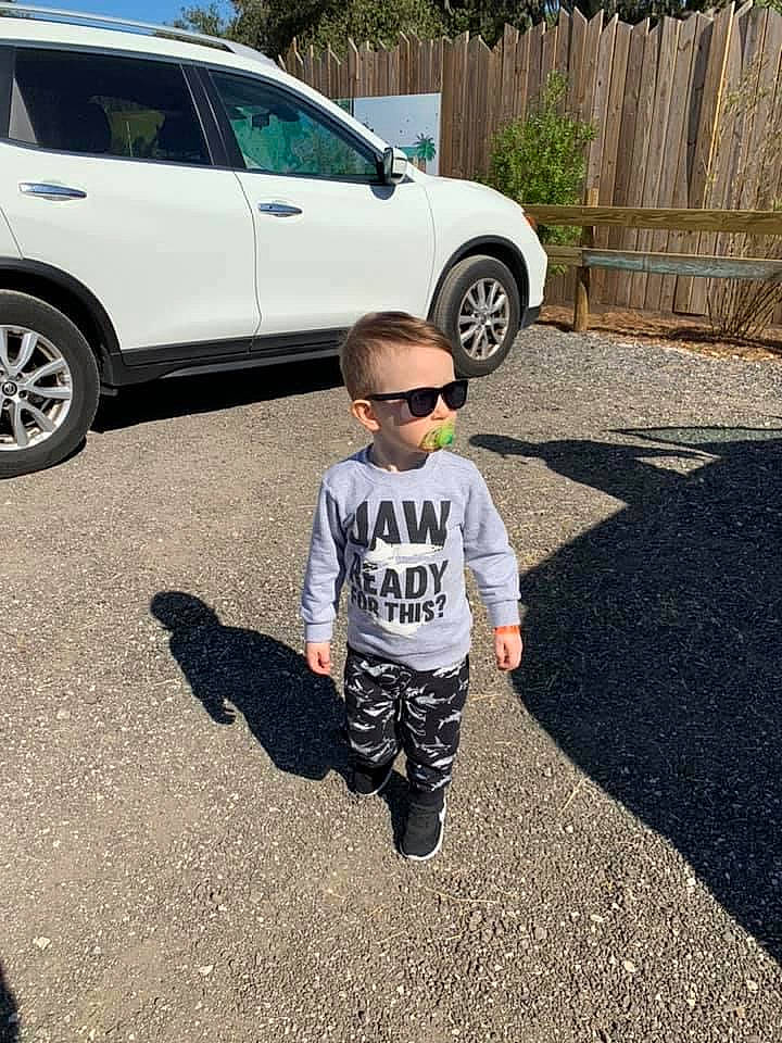 Benton is registered to the contest to win money with this photo: asphalt, automotive_design, automotive_tire, car, child, compact_sport_utility_vehicle, crossover_suv, family_car, flooring, infrastructure, metal, minivan, person, plant, road, sidewalk, sport_utility_vehicle, tire, vehicle, vehicle_door