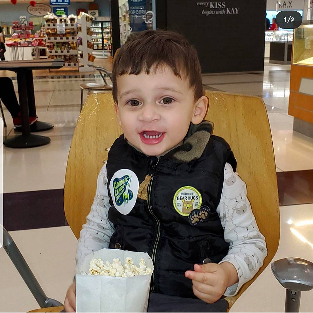 Carter is registered to the contest to win money with this photo: child, comfort_food, food, outerwear, person, snack, toddler