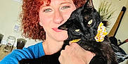 Walter Peepeekay joined the competition — help win amazing prizes! animal, black_cat, blue_shirt, cat, cozy, curly_hair, cute, face, flower_collar, furniture, holding, home, indoor, painting, person, pet, portrait, shelf, smiling, window