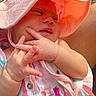 Avalon is registered to the contest to win money with this photo: baby, child, sunhat, pink, striped_clothing, hand, fingers, intertwined, closeup, portrait, outdoor, sunlight, cute, infant, person, skin, warm_light, relaxed, colorful, summer