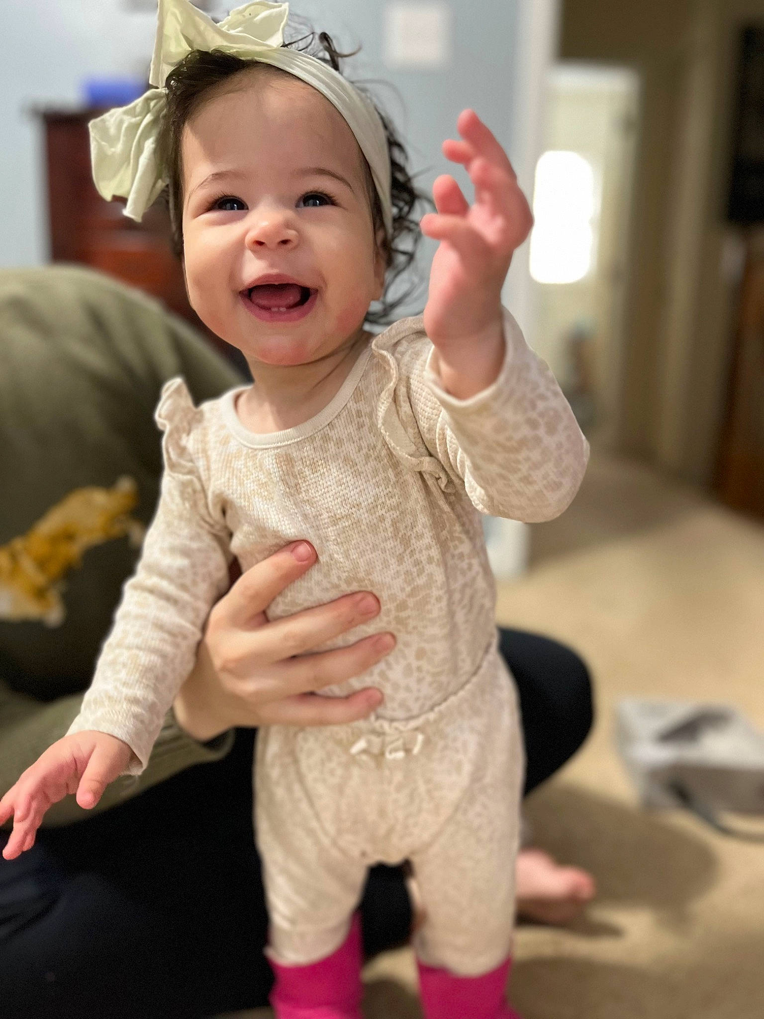Ella is registered to the contest to win money with this photo: baby, baby_toddler_clothing, cap, child, event, eye, facial_expression, fashion_accessory, finger, fun, gesture, hand, happy, headgear, headwear, person, pink, skin, sleeve, smile