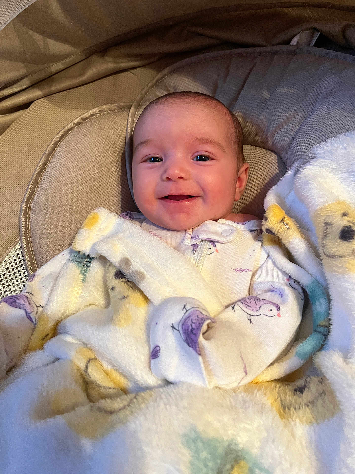 Maelea is registered to the contest to win money with this photo: baby, infant, smiling, blanket, bird_pattern, cushion, soft_texture, cozy, child, face, apparel, sleepwear, happy, portrait, indoor, comfort, newborn, closeup, resting, cute