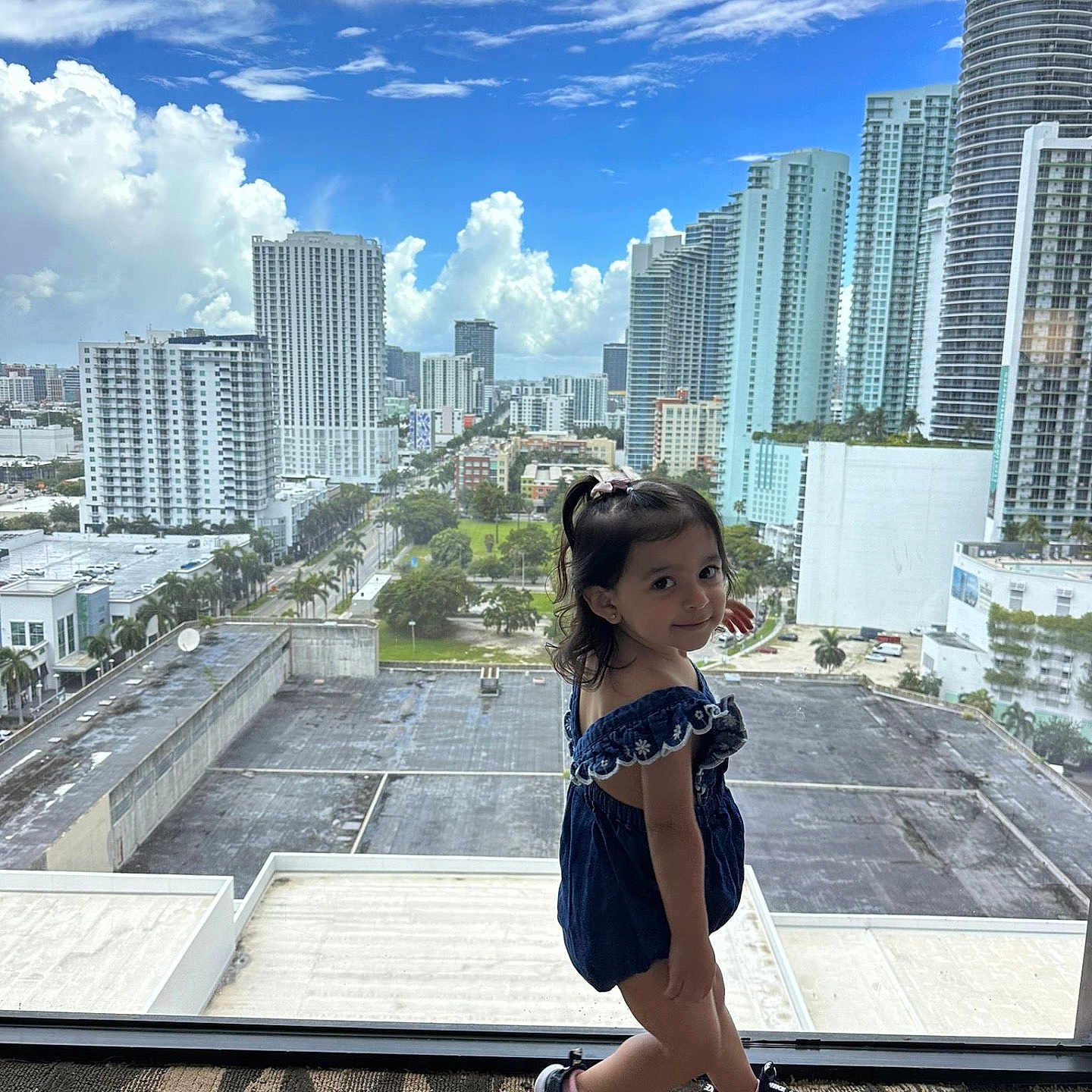 Selena joined the competition — help win amazing prizes! architecture, building, child, city, cityscape, condo, downtown, face, female, girl, head, highrise, housing, officebuilding, person, photography, portrait, sitting, standing, urban