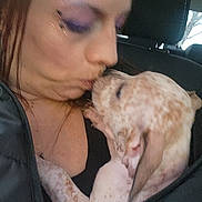 Kitana Kitty Lee joined the competition — help win amazing prizes! woman, puppy, dog, kiss, affection, closeup, car_interior, seat, headrest, jacket, makeup, purple_eyeshadow, spotted_fur, pet_owner, cuddle, lap, portrait, blurry, intimacy, cute