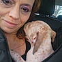 Kitana Kitty Lee is registered to the contest to win money with this photo: woman, face, dog, puppy, car_interior, headrest, makeup, purple_eyeshadow, speckled_fur, closeup, portrait, smile, jacket, seat, window, skin, ear, nuzzle, cuddling, passenger