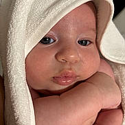 Mateo is registered to the contest to win money with this photo: baby, infant, face, skin, towel, arm, cheeks, eyes, lips, closeup, soft, cute, newborn, wrapped, resting, expression, indoors, human, portrait, baby_skin
