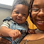 Kyndyl is registered to the contest to win money with this photo: baby, adult, smiling, denim, overalls, glasses, tattoo, indoor, portrait, holding, child, person, happy, cute, clothing, face, hand, skin, hair, casual