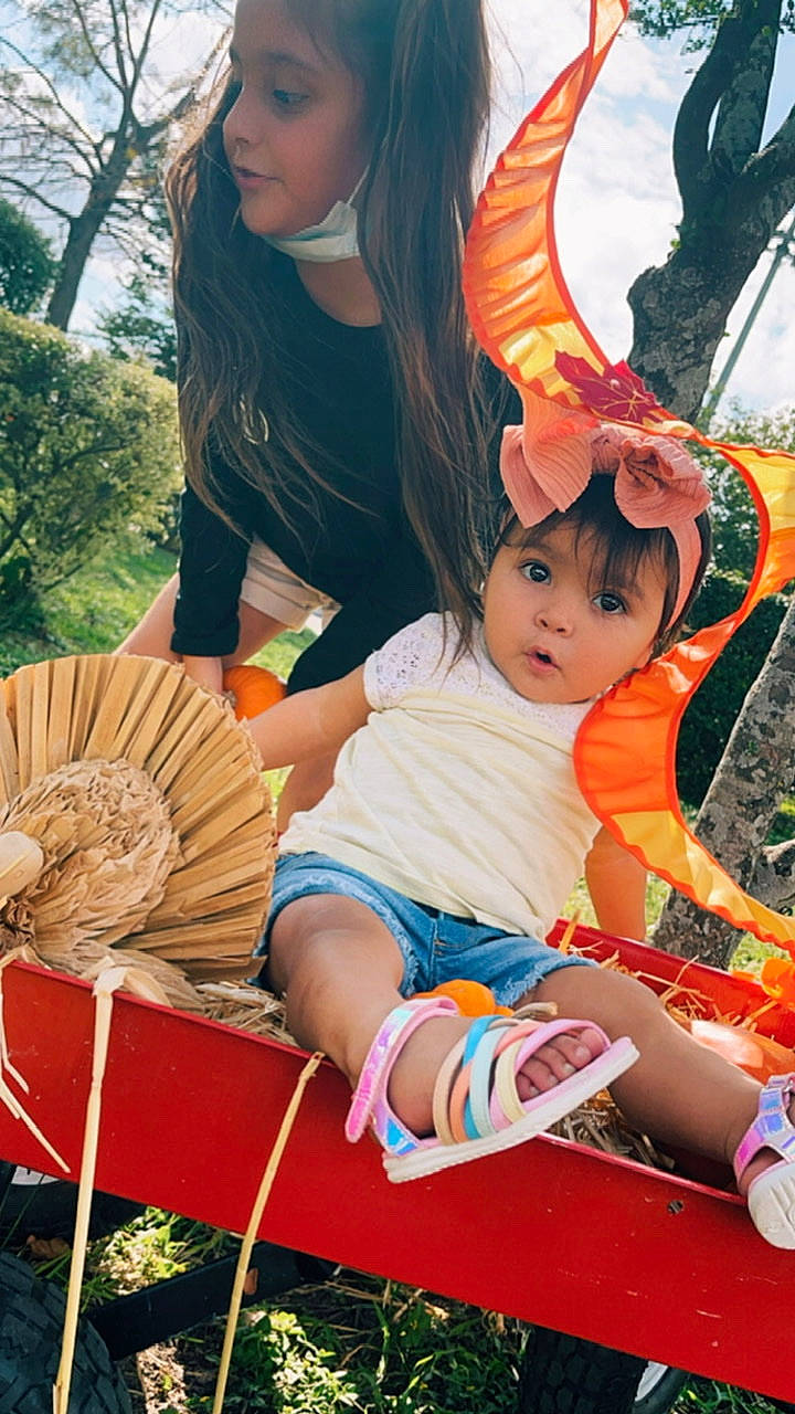 Madalynn is registered to the contest to win money with this photo: arm, beauty, child, fashion, fawn, fun, grass, hairstyle, happy, leisure, orange, people, people_in_nature, person, recreation, shorts, summer, surprise, thigh, toddler