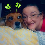 Dixie joined the competition — help win amazing prizes! dog, person, glasses, blanket, pattern, indoor, face, smile, pet, resting, cozy, cute, clover, antenna, digital_effect, brown_dog, human, bedroom, closeup, together