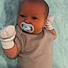 Luca joined the competition — help win amazing prizes! baby, infant, pacifier, mittens, onesie, quilt, blue, beige, newborn, child, cute, portrait, laying_down, soft_texture, indoor, sleepwear, human, young, resting, person