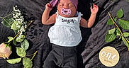 Naomi joined the competition — help win amazing prizes! baby, infant, newborn, pacifier, headband, flower_arrangement, roses, baby's_breath, black_blanket, one_month_marker, peaceful, sleeping, cute, purple_headband, white_top, black_pants, skin, small_feet, nature, soft_light