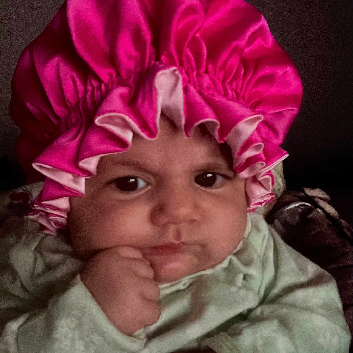 Malibu is registered to the contest to win money with this photo: baby, bathingcap, bonnet, cap, clothing, coat, face, hat, head, newborn, person, photography, portrait