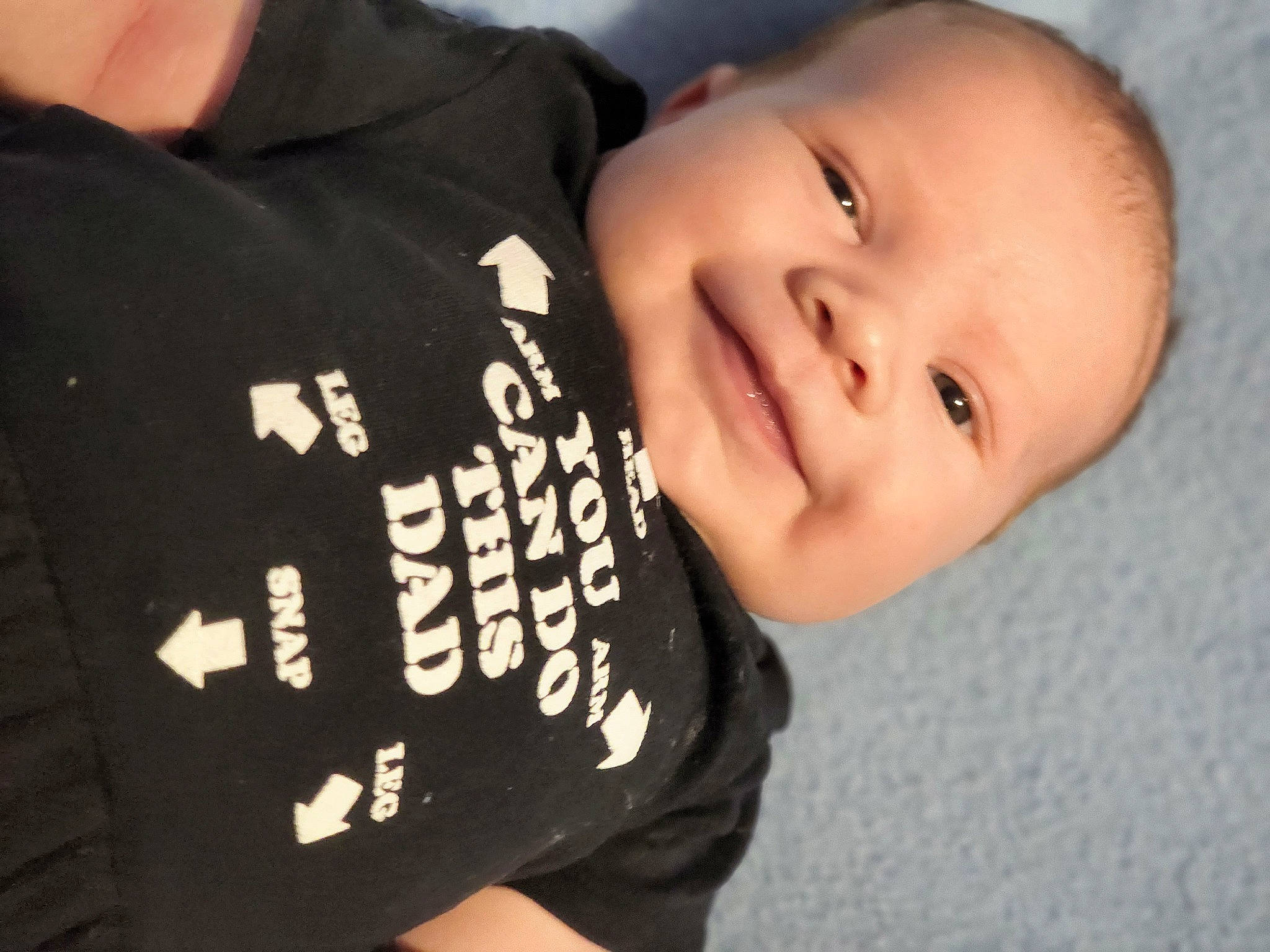Echo is registered to the contest to win money with this photo: baby, baby_toddler_clothing, cheek, child, comfort, elbow, finger, flash_photography, font, fun, gesture, happy, joy, neck, nose, person, portrait_photography, sleeve, smile, t_shirt