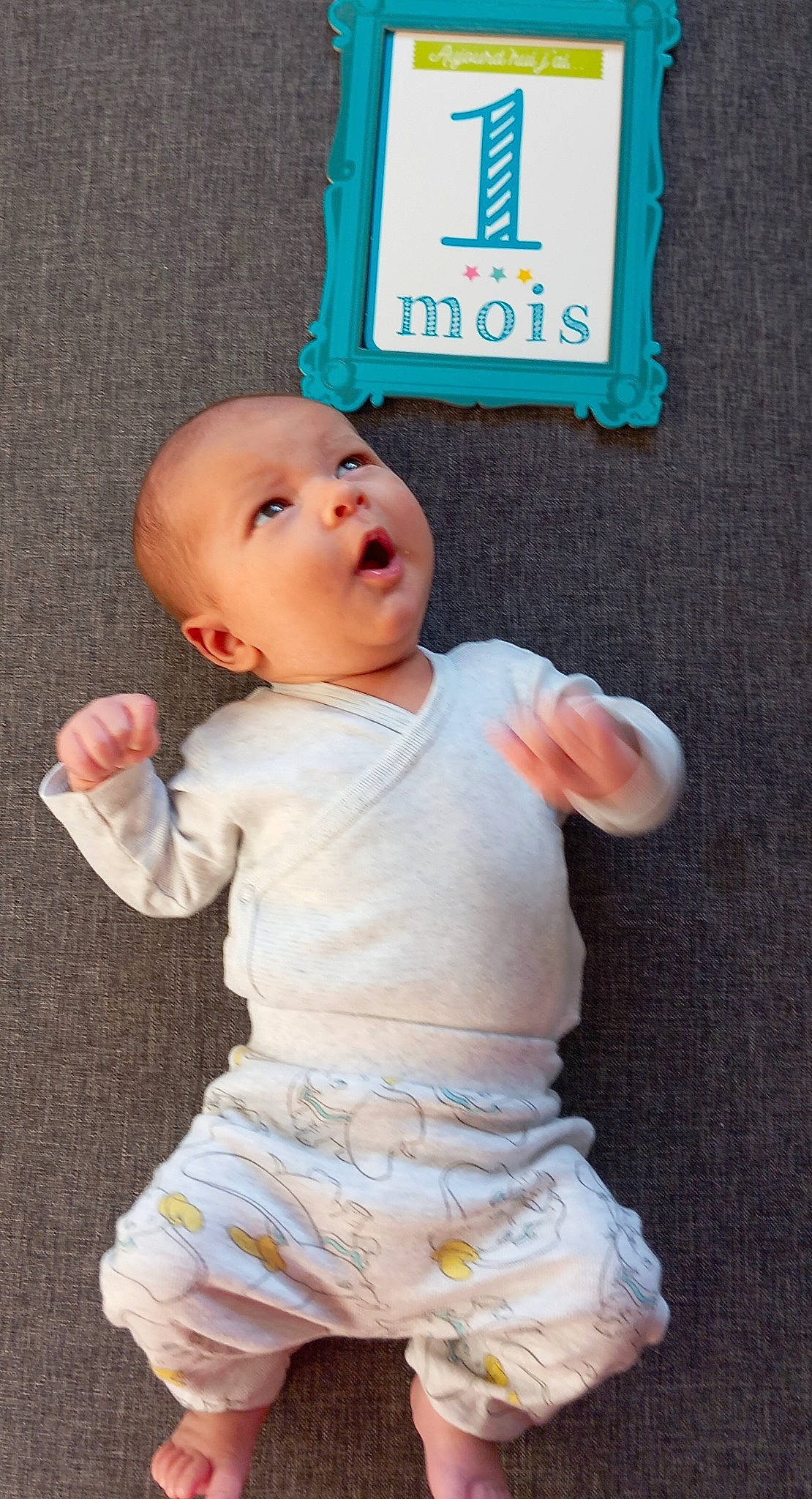 Matt participe au concours pour gagner de l'argent avec cette photo : baby, baby_products, baby_toddler_clothing, blue, cheek, child, finger, gesture, hand, happy, pattern, person, pink, product, sitting, skin, sleeve, t_shirt, thumb, toddler