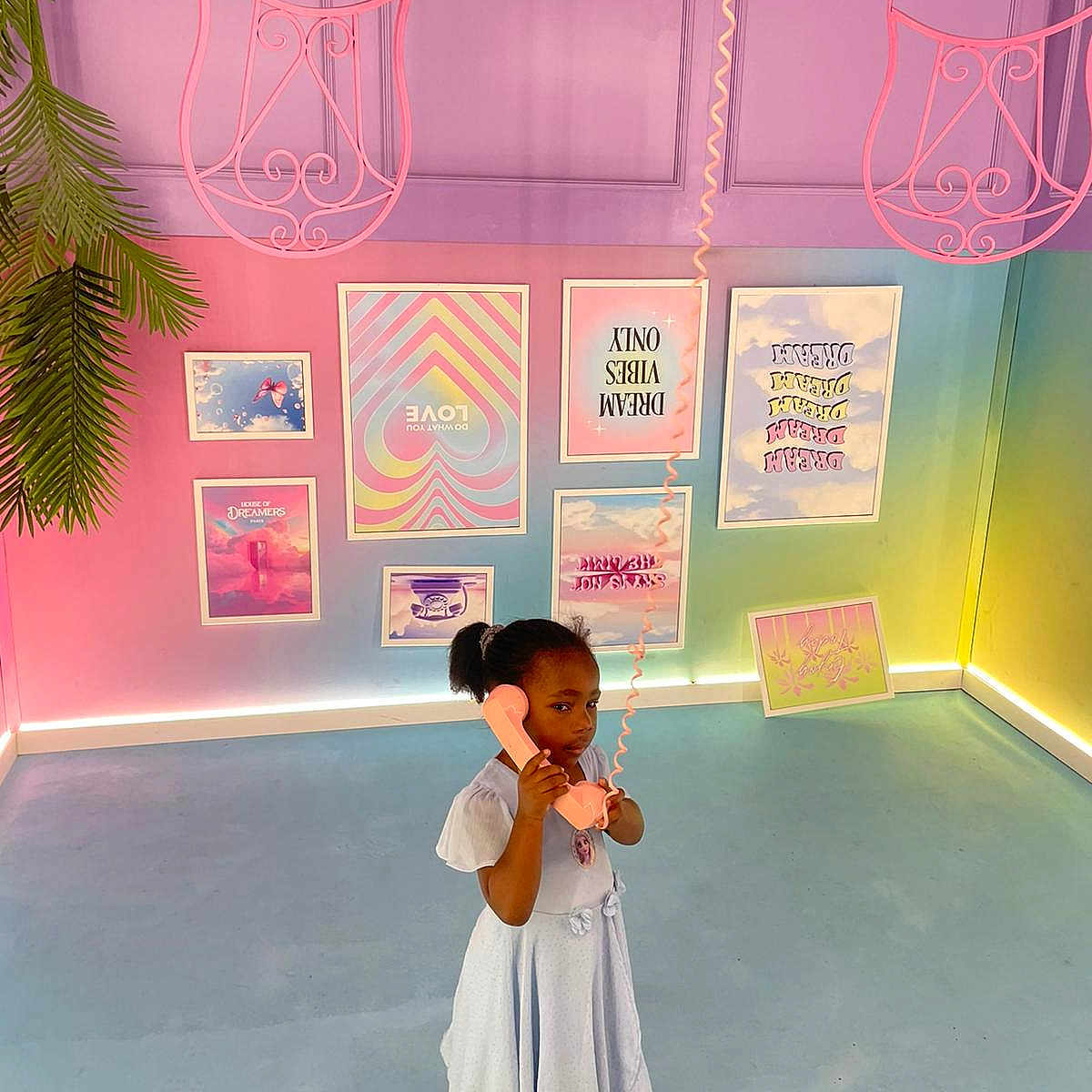 émilienne participe au concours pour gagner de l'argent avec cette photo : artistic, black_hair, child, colorful_room, curly_hair, decoration, floor, framed_posters, girl, indoor, pastel_colors, phone, phone_receiver, pink_sandals, playful, retro_phone, toy, upside_down_chairs, wall_art, white_dress