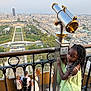 émilienne participe au concours pour gagner de l'argent avec cette photo : braided_hair, child, cityscape, daylight, girl, landscape, metal, observation_deck, outdoor, park, people, railings, sky, summer_dress, telescope, tourist, travel, urban, vacation, viewpoint
